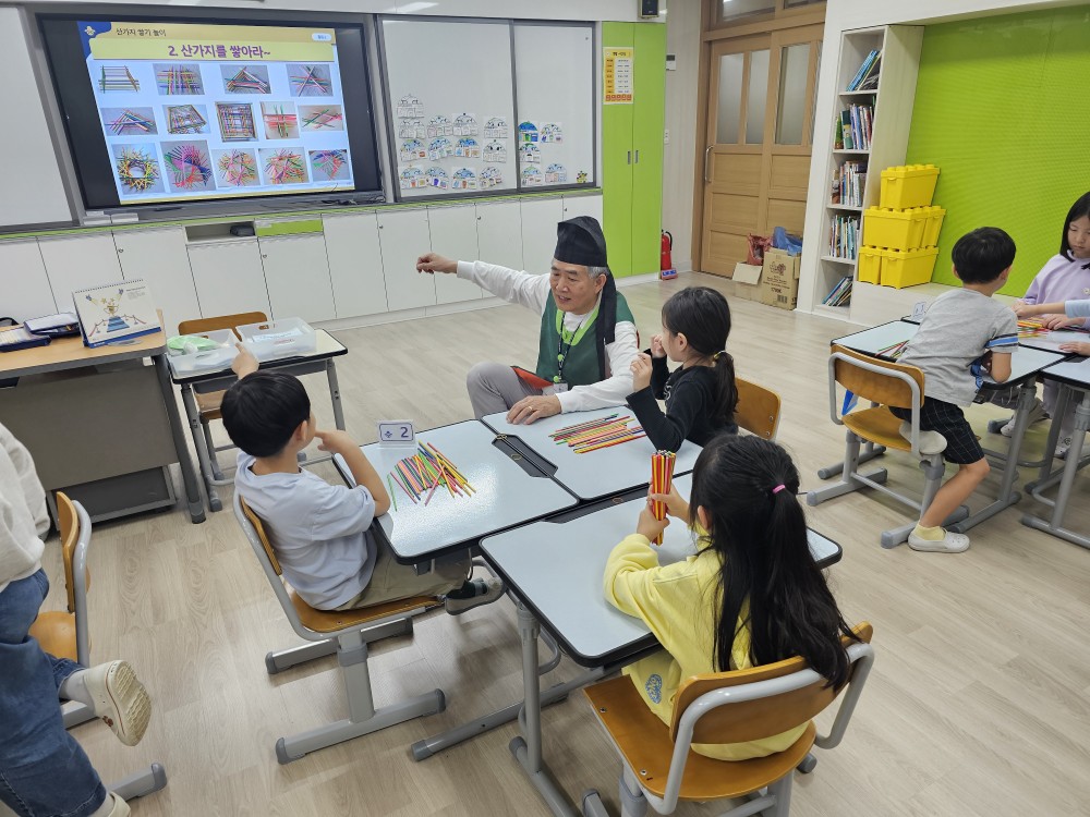 1. 용연초등학교 1학년 학생들이 16일 교실에서 전통 나눔 할아버지에게 산가지 놀이를 배우고 있다 (1).jpg